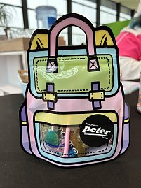 Bunte Tüte im Schulranzen-Design mit Autohaus Peter-Sticker und kleinen Süßigkeiten