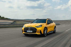 Man sieht den ersten vollelektrischen AMG GT aus dem SUV-Segment in einem kr&auml;ftigen gelb. Das Fahrzeug f&auml;hrt in Fahrtrichtung links auf einer Stra&szlig;e. 